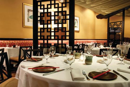 a table in a restaurant with white tablecloths and glasses at The Royal at Atlantis in Nassau