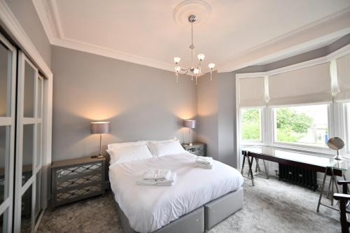 a bedroom with a bed and a desk and a piano at The Old Manse in Ayr