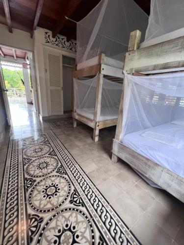 a bedroom with two bunk beds and a rug at Hostal Secreto in Isla Grande