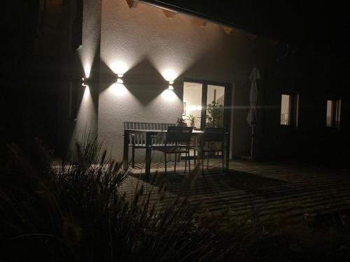 a porch with a bench and lights on a house at Vulkanland Stoeckel - Feldbach in Feldbach