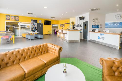 a living room with a couch and a table at Sport Arena Hotel in Waldshut-Tiengen