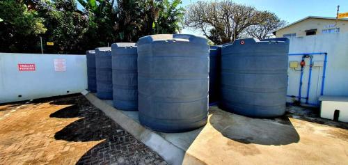 a group of barrels lined up next to a fence at Breathtaking 3 Bedroom unit with amazing sea views in Ramsgate