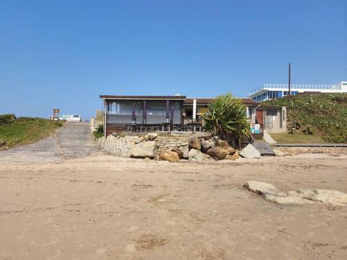 a house on the side of a beach at Breathtaking 3 Bedroom unit with amazing sea views in Ramsgate