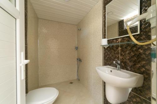 a bathroom with a white sink and a toilet at Enda Lara Hotel in Antalya