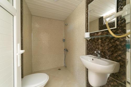 a bathroom with a white sink and a toilet at Enda Lara Hotel in Antalya