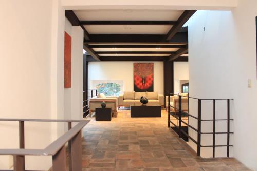 a view of a gallery with couches and paintings at Hotel Casa Cantera in Oaxaca City