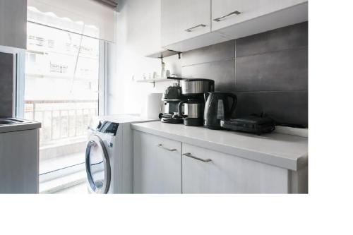 a kitchen with a counter top with a coffee maker at Central faliro Apartment near to marina in Athens