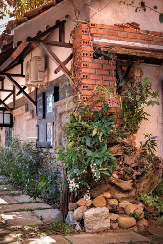 a building with a bunch of plants on the side of it at Y.O Inn in Kon Tum
