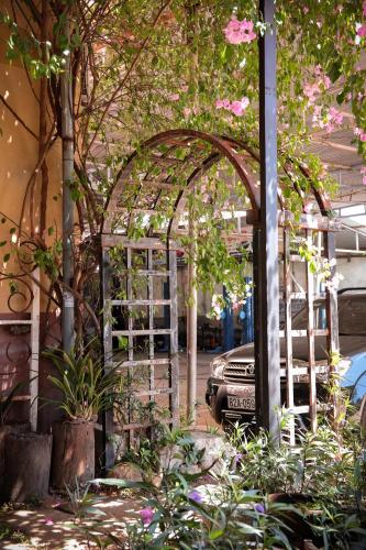 a greenhouse with pink flowers in a parking lot at Y.O Inn in Kon Tum
