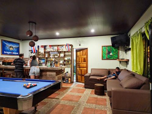 a living room with a pool table in it at Hostel Tortuguero 7BackPackers in Tortuguero
