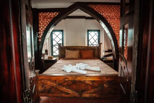 a bedroom with a bed with two towels on it at Y.O Inn in Kon Tum