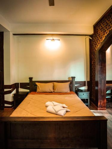a bedroom with a bed with two towels on it at Y.O Inn in Kon Tum