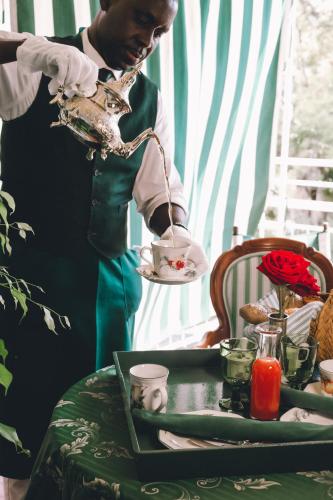 a man holding a plate with a bird on a table at Eveline Portosole Hotel in Sanremo