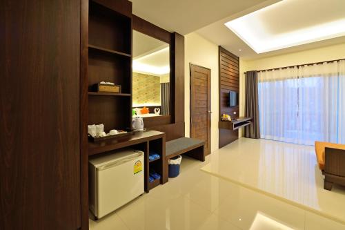 a kitchen with a white refrigerator in a room at Poonsiri Resort Aonang-SHA Extra Plus in Ao Nang Beach