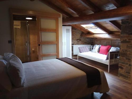 1 dormitorio con 1 cama y 1 sofá en una habitación en CASA EL TEIXO, en Taramundi