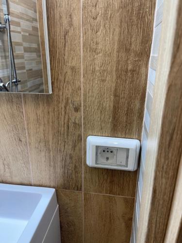 a bathroom with a sink and a clock on the wall at Casa Di Carla in Canino