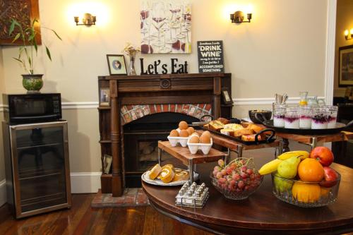 a living room with a fireplace with a bunch of food at The Inn at 161 in Sutter Creek