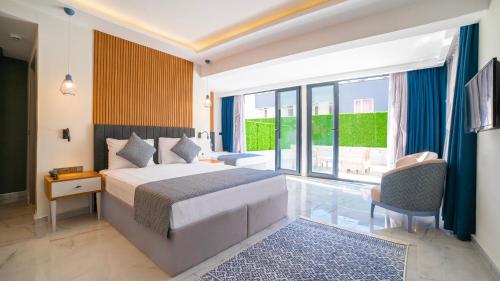 a bedroom with a bed and a large window at HOTEL DESTİLL in Antalya