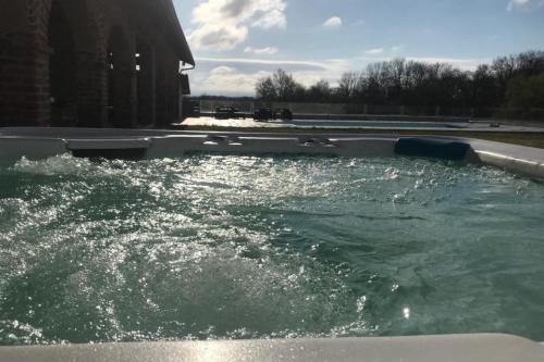 a pool of water in a swimming pool at Family villa at 1H15 from Lyon in Prétieux