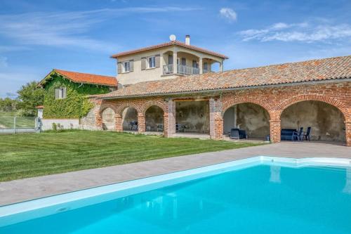 a house with a swimming pool in front of a building at Family villa at 1H15 from Lyon in Prétieux