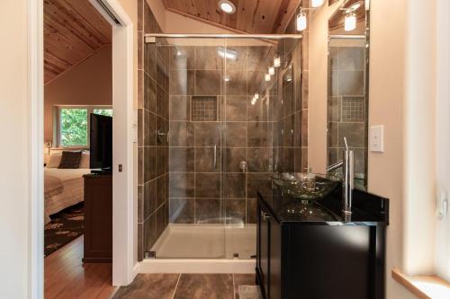 a bathroom with a shower with a black counter at Moonlight Ridge - Powder Horn Mountain in Powderhorn Mountain