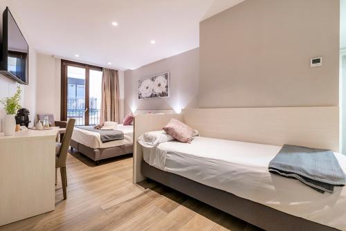 Ένα ή περισσότερα κρεβάτια σε δωμάτιο στο Hotel Centre Reus