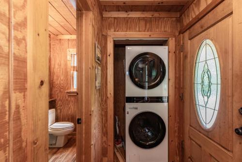 a bathroom with a washer and dryer in a house at Twin Creeks Cabin - Anglers Retreat! in Powderhorn Mountain