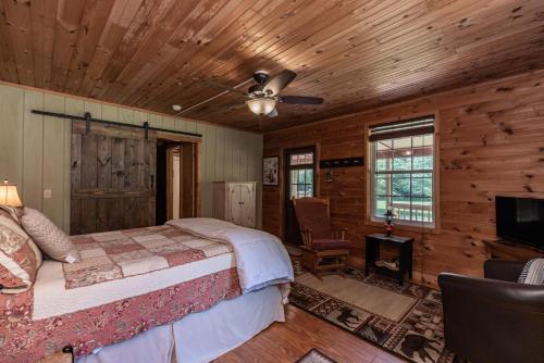 a bedroom with a bed and a ceiling fan at Twin Creeks Cabin - Anglers Retreat! in Powderhorn Mountain