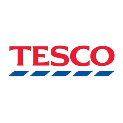 a red tesco logo on a white background at Hotel Time Boutique Nilai in Nilai