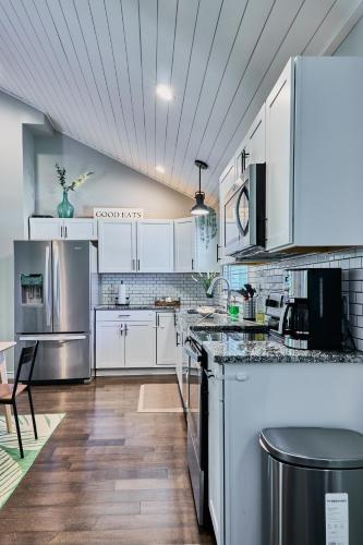 a kitchen with white cabinets and stainless steel appliances at Private Peaceful House near Lake Lure Chimney Rock in Rutherfordton
