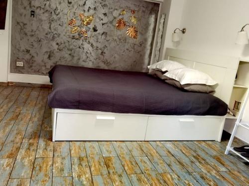 a bedroom with a bed with a wooden floor at Stay In Tmisoara in Timişoara