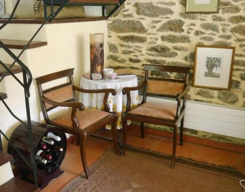 two chairs and a table in a room at Wonderful 4 Bedroom Villa & separate guest house Villa Thalia in Zagora