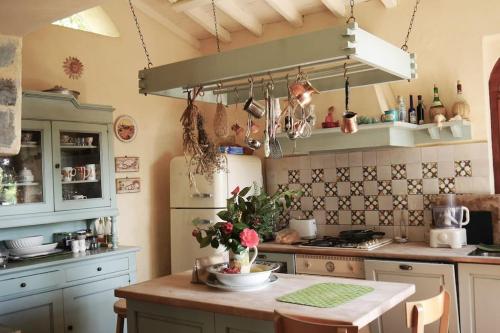 a kitchen with a table with flowers on it at Wonderful 4 Bedroom Villa & separate guest house Villa Thalia in Zagora