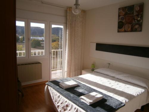 a bedroom with a bed with two towels on it at Mirador Alegre in El Burgo de Osma