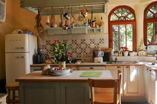 a kitchen with a table and a refrigerator at Wonderful 4 Bedroom Villa & separate guest house Villa Thalia in Zagora