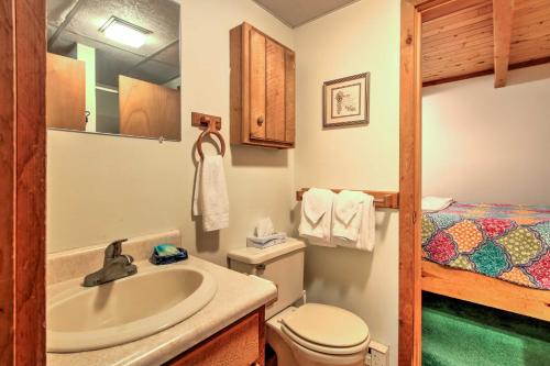 a bathroom with a sink and a toilet and a bed at Cozy Bartlett Townhome Less Than 3 Mi to Attitash Mountain in Bartlett
