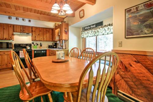 a kitchen and dining room with a wooden table and chairs at Cozy Bartlett Townhome Less Than 3 Mi to Attitash Mountain in Bartlett