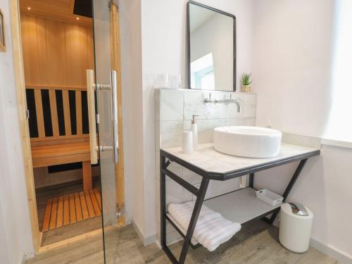a bathroom with a sink and a mirror at Rose Cottage in Clitheroe