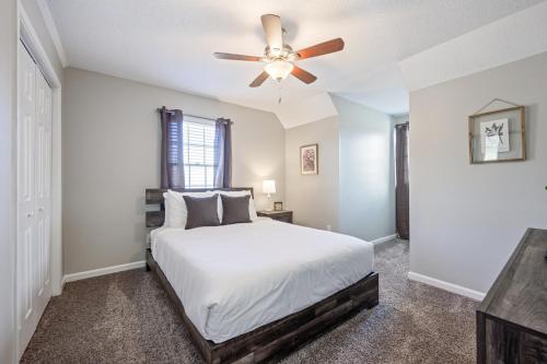 a bedroom with a bed and a ceiling fan at Embrace The Outdoors In This Modern Rydal Setting in White