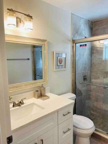 a bathroom with a toilet and a sink and a shower at Luxury • Modern • CLOSE2DISNEY • 3bed • 2bath in Kissimmee
