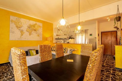 a dining room with a black table and chairs at Cinque Terre d'Amare sea view big apartment for travel lovers in Riomaggiore