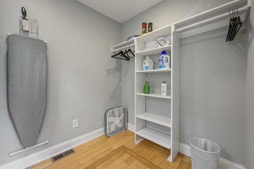 a bathroom with a closet with white shelves at Plan A Trip To Georgia Aquarium In This Comfy 3BR in Atlanta