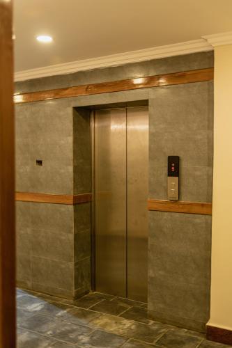 a elevator in a building with a metal door at Hotel Fewa Camp in Pokhara