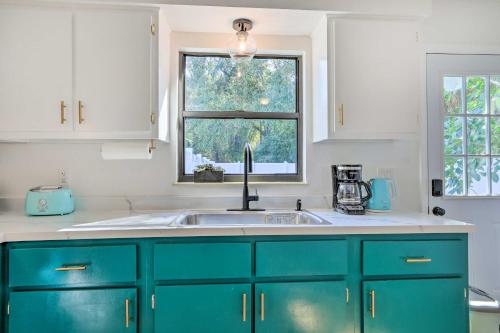 a kitchen with blue cabinets and a sink at Refreshing Gulfport Escape Boat, Fish and More in St. Petersburg