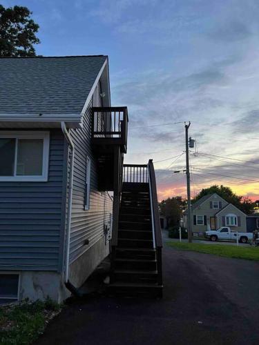 a house with a staircase next to a house at 1Guest House Baltimore County (own room, Joppa RD) in Parkville