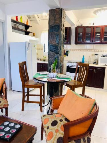 a kitchen with a table and chairs in a room at Villa Marcia in Boca Chica