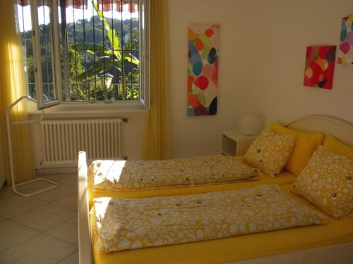 um quarto com 2 camas e uma janela em Casa Solaria em Gordola