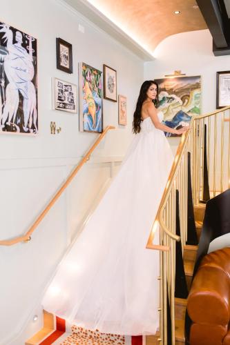 a bride walking down the stairs in her wedding dress at Virgin Hotels New Orleans in New Orleans