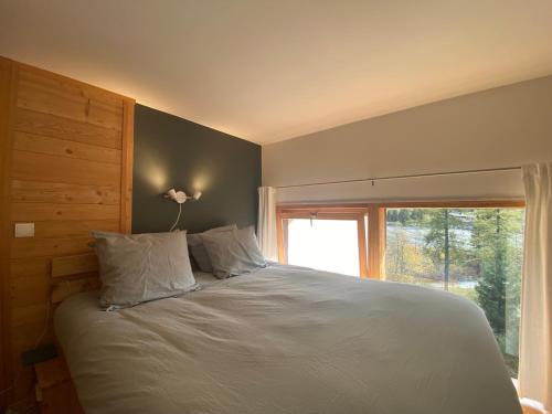 a bedroom with a large bed with a window at Residence Grand Roc - Kercham in Chamonix-Mont-Blanc
