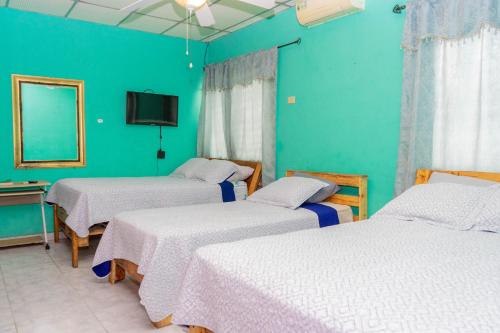 A bed or beds in a room at Hostal Familiar Argeñal